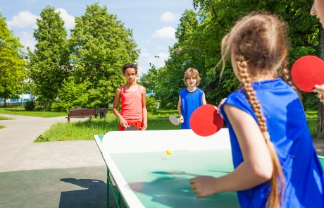 Four international friends play table tennis